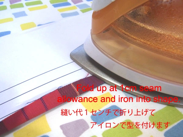 Folding seam allowance 1 cm with an iron using cardboard guide