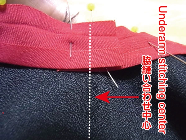 Pinning bias tape around the armhole seam allowance