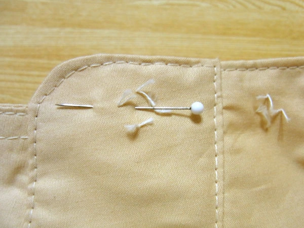 Marking the buttonhole starting point with a pin