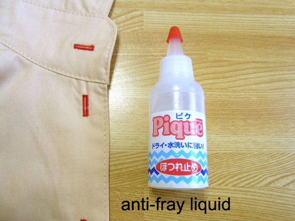 Applying anti-fray liquid to buttonholes