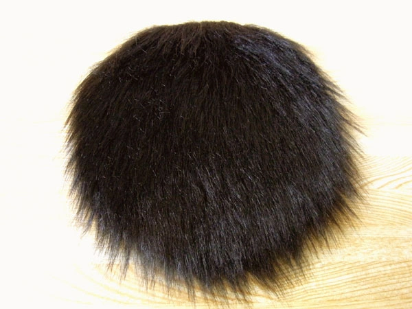 Cutting fur fabric into a circle to make a furry bulb