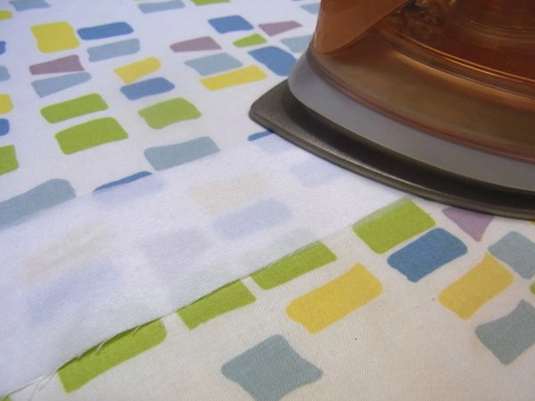 Iron interfacing to the facing fabric