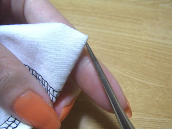 Adjusting hem corners with tapered awl