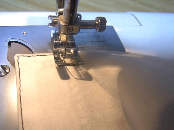 Stitching hem seam allowance to facing
