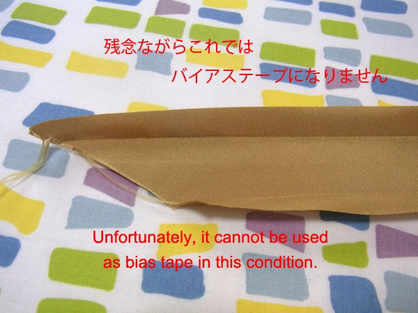 Golden satin bias tape opening up after ironing